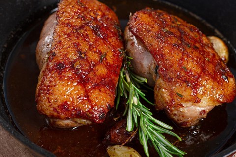 Roast duck breast, in a frying pan, with spices and herbs, close-up, no people
