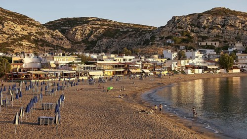 Small coastal town with beach and houses at dusk, Matala, South Coast, Crete, Greek Islands, Greece