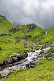 Bergbach Sousbach flows through picturesque green mountain landscape, Bernese Alps, Bernese