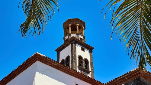 Church, Iglesia Nuestra Senora de la Concepcion, colonial tower framed by palm trees under blue