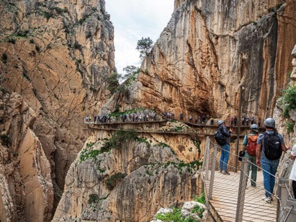 Tourists on the elevated path of the caminito del rey, along a deep gorge, Andalusia, Spain