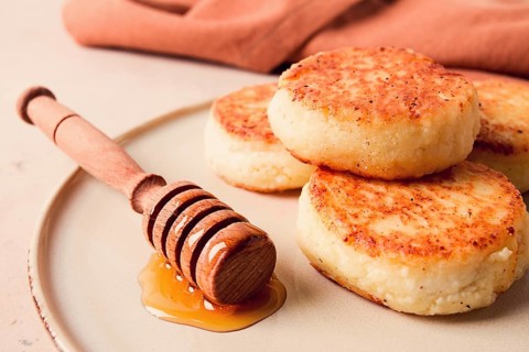 Cottage cheese pancakes, with honey, close-up, on a beige table, selective focus, no people