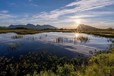 Pond with mountains at sunset, view of Mount Hoven, Gimsoy, Lofoten, Norway
