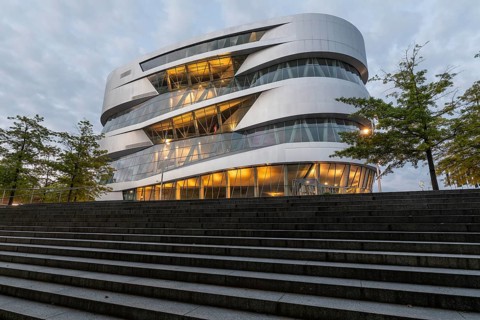 08.05.2026 Illuminated Mercedes Benz Museum with futuristic architecture and stairs at dusk in
