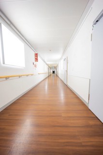 Long, bright corridor with wooden floors and minimalistic design, old disused hospital, Calw,