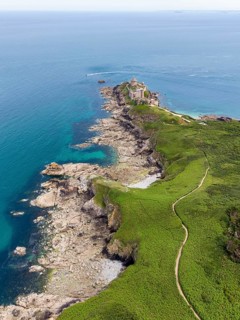 Aerial view of the historic rock castle Fort la slat, Château de la Roche Goyon on a rocky headland