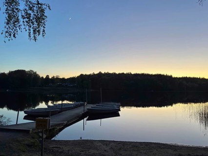 Jetty with boats in a calm lake at dusk, camping, vacation, Karlshamm, Blekninge, Sweden