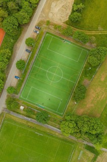 Aerial view of a soccer field with surrounding trees and roads, Aidlingen sports field, Böblingen