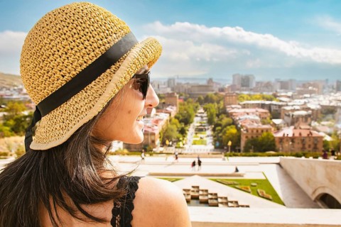 Close up Happy caucasian tourist woman on viewpoint pose enjoy sightseeing Yerevan city landmarks