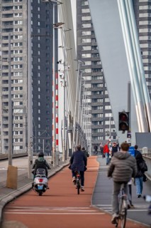 The Erasmus bridge over the Nieuwe Maas in Rotterdam, pedestrians, two-wheelers, cars, tram