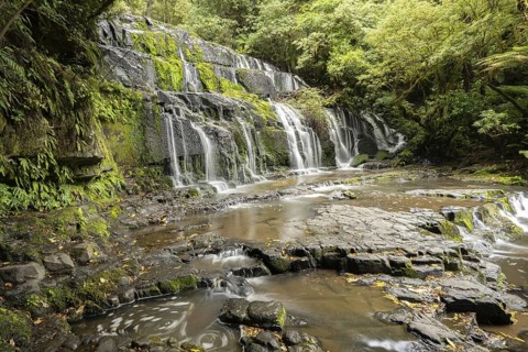Waterfall of Purakaunui Falls in dense forest with rocks, Purakaunui, Owaka, New Zealand, Oceania