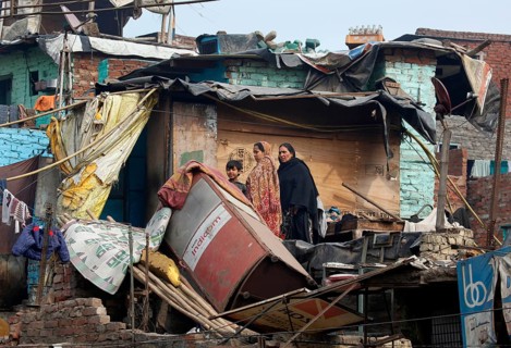 New Delhi, India, 15.01.10 - Dilapidated residential area, two woman with children in a neglected