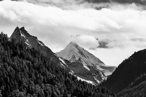 Snow-covered peaks of the mountains Le Besso and Obergabelhorn, black and white photo, Val
