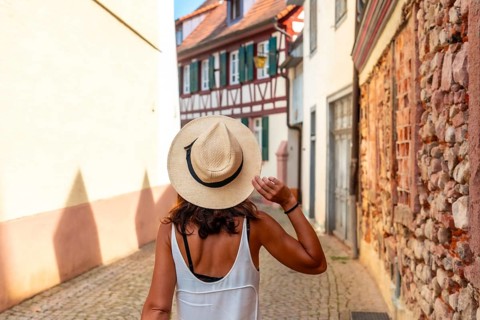 A female tourist walking in the village of Gengenbach in the Black Forest, Germany