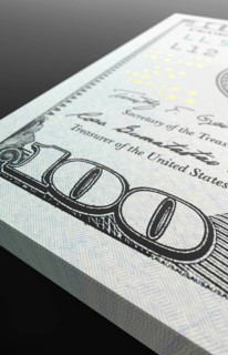 Ten thousand dollar stack of one hundred dollar bills close-up abstact.