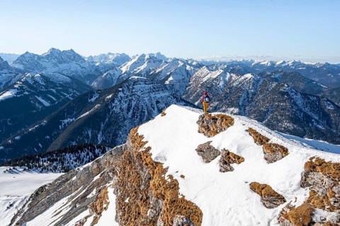 Ski tourers at the summit of Schafreuter, view of snowy mountain panorama, Karwendel, Tyrol,