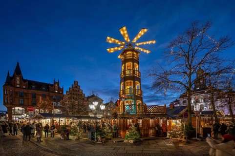 Christmas market with large Christmas pyramid on the market square, behind the historic town hall,