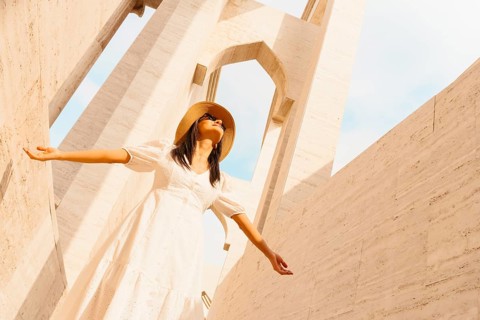 Doha Qatar Katara Cultural Village woman in white dress walking amphitheater traditional