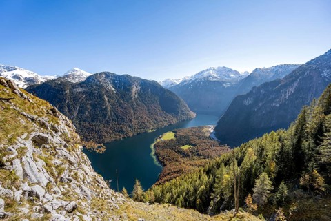 View of the Königssee from the Rinnkendlsteig mountain hiking trail, autumnal forest and