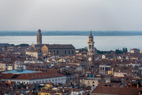 View over the roofs of Venice to the steeple of the church Chiesa Parrocchiale dei Santi Apostoli,