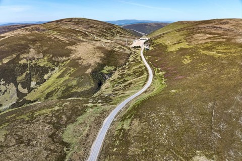 Aerial drone view of the highland landscape with skiing and outdoor sports station above Braemar,