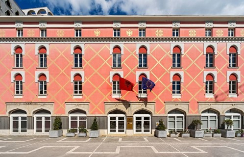 The distinctive pink facade with yellow geometric patterns of the Ministry of Agriculture featuring