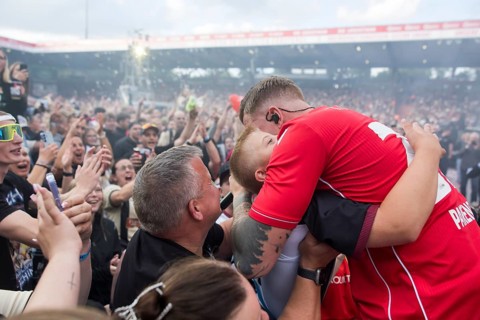 Finch (real name: Nils Wehowsky) hugs a guest live during Finchi's ‘Heimspiel' tour at the Stadion