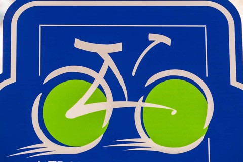 Close-up of speeding white bicycle with big bright fluorescent lime green wheels illustration on