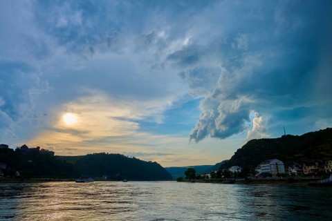 Sunset over a river with dramatic clouds and hills on the horizon, St. Goar, St. Goarhausen, Rhine,