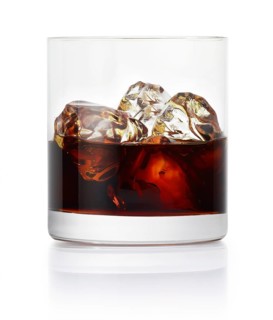 Drink on ice cube cubes in a tumbler in front of a white background, studio shot