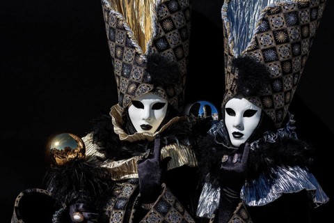 Venetian carnival masks and costumes at the Venetian fair on the historic market square,