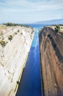 Raised angle view of narrow Corinth Canal and steep limestone walls, linking Gulf of Corinth with