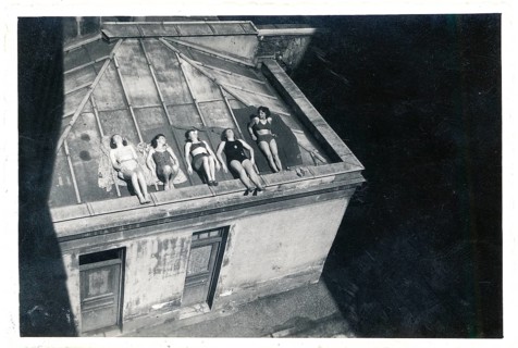 Bathing, swimwear, leisure, summer, woman in bathing suits sunbathing on a sloping flat roof,