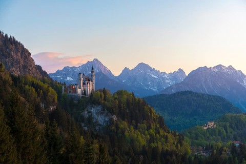 Wide view of Neuschwanstein Castle against an alpine backdrop, Schwangau near Füssen, Ostallgäu