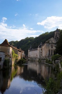 Medieval houses and Benedictine abbey Saint-Pierre de Brantôme on the Dronne river in the evening