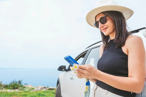 Close up Portrait of pretty happy woman using her smartphone type, chat, planning trip use social