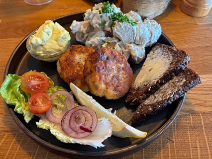 Colourful food on a plate with fish cakes, potato salad and fresh vegetables, Bornholm, Denmark