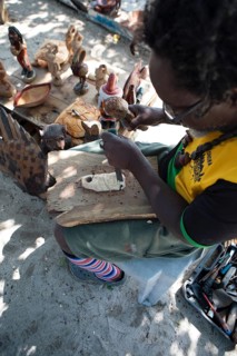 Jamaican man, 61 years old, carves a Santa Claus figure on Booby Cay Island, Negril, Westmoreland
