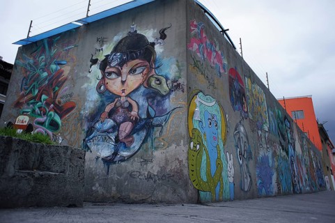 Colourful graffiti art on a concrete wall with imaginative cartoon characters, Quito, Ecuador