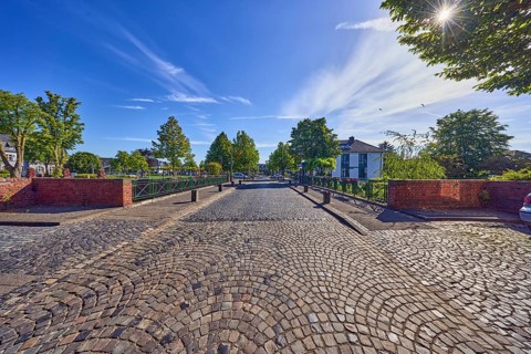 Car bridge and footbridge, general buildings, houses, metal railings, barrier bollards, sidewalk,