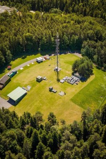 Close-up of a radio tower surrounded by thick forest and an open meadow, bunker complex, Calw,