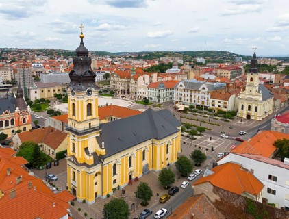 Baroque church rises above the surrounding urban landscape with historic roofs, aerial view, St.