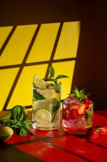 Refreshing mojito cocktails displayed on a vibrant table. A classic mojito with lime and mint