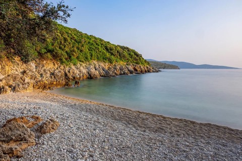 Crystal clear and turquoise water on the beach of Ustrine Bay on a sunny day at sunset on the