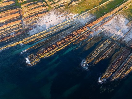 Colourful rocks on the coast, aerial view, Varanger, Barents Sea, Finnmark, Norway