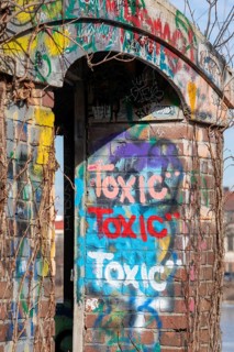 Detroit, Michigan - Graffiti reading toxic is painted on an abandoned pedestrian bridge on Belle