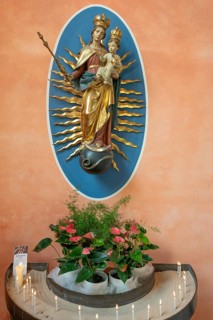 Marian altar with sacrificial candles in the church of St Stephanus, Art Nouveau building with