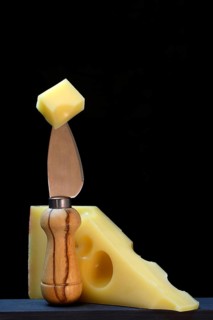 A piece of Swiss Emmental cheese on a cheese knife