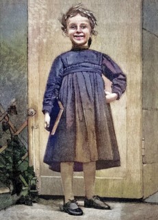 Girl, wears a dark dress typical of the time with long sleeves and a ruched waistband as well as