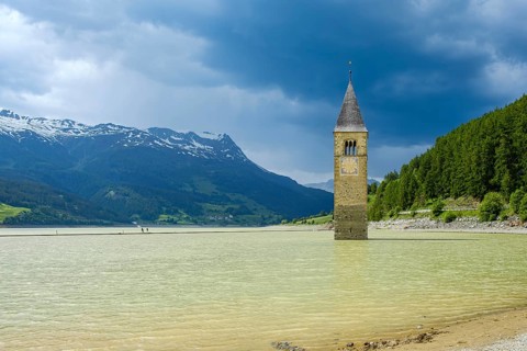 Bell tower of the former parish church of St Catherine in the sunken village of Alt-Graun in Lake